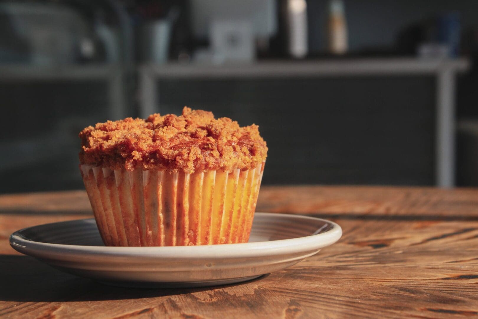 A muffin on top of a white plate.